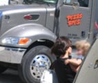 Parent and baby waiting for truck on Karen Road