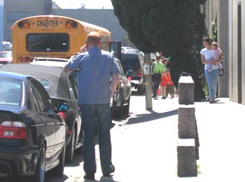 San Mateo Gymnastics front, people, school bus