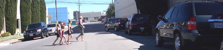 Crossing Elmer Street, walking towards San Mateo Gymnastics from Pump It Up parking lot